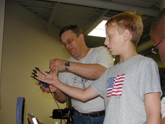 Eric Lundquist aids in putting on the P5 Glove